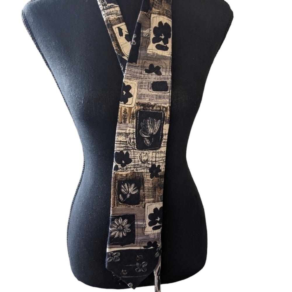 Guy LaRoche silk tie . Black and grey with a floral print.